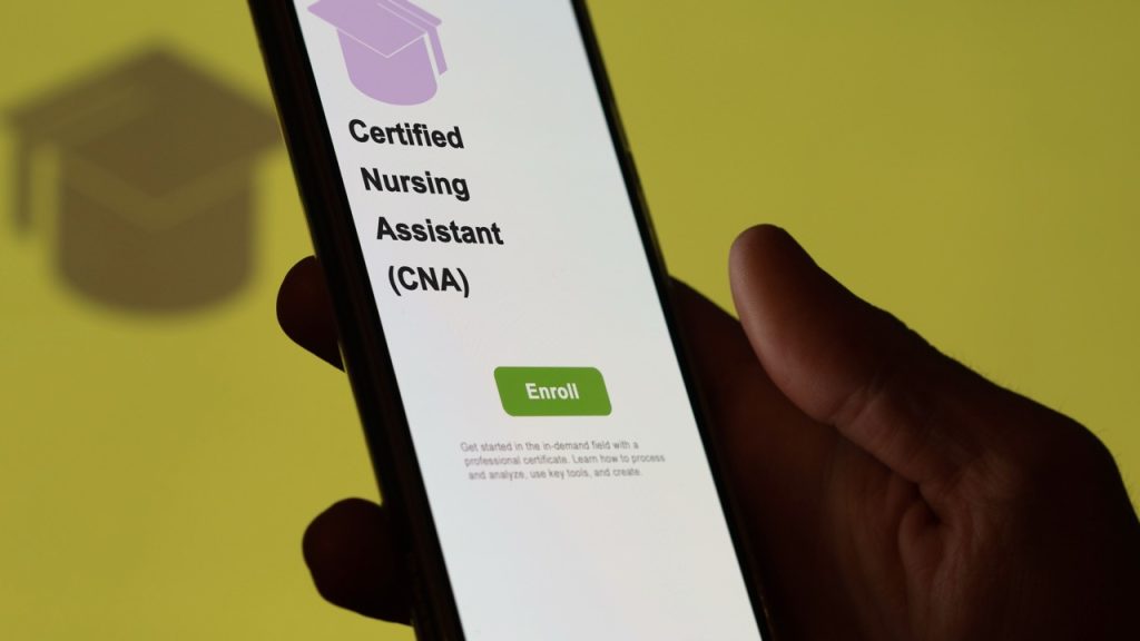 A close-up of a smartphone screen displaying an enrollment page for a Certified Nursing Assistant (CNA) program.